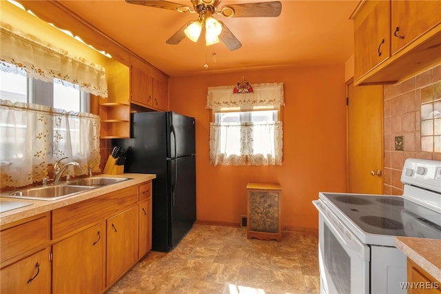 kitchen with decorative backsplash, electric stove, a wealth of natural light, and a sink