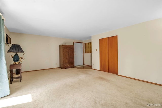 unfurnished bedroom with a closet, baseboards, and carpet flooring