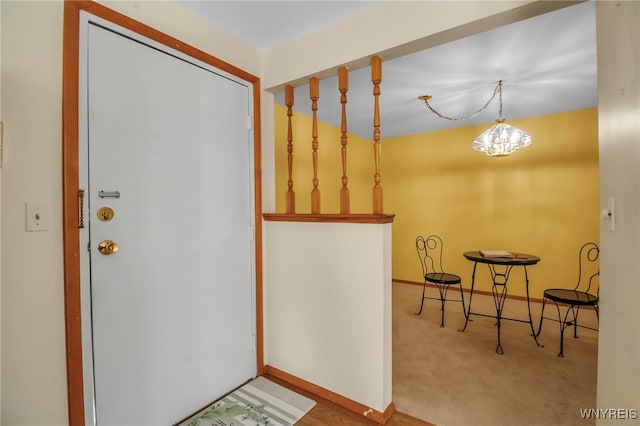 entryway featuring baseboards and carpet