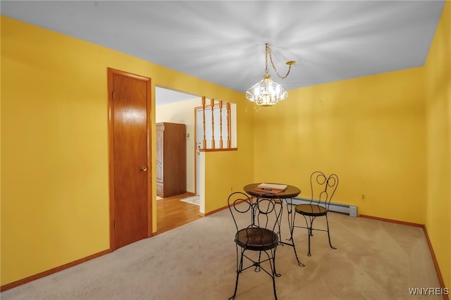 carpeted dining area with baseboards and a chandelier