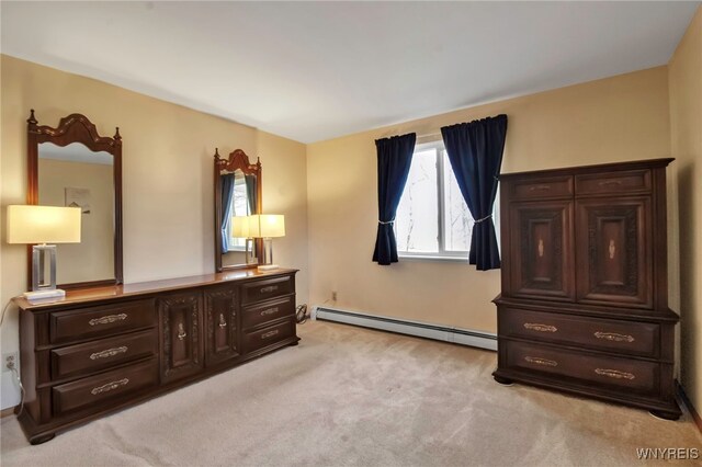 bedroom with a baseboard heating unit and light carpet