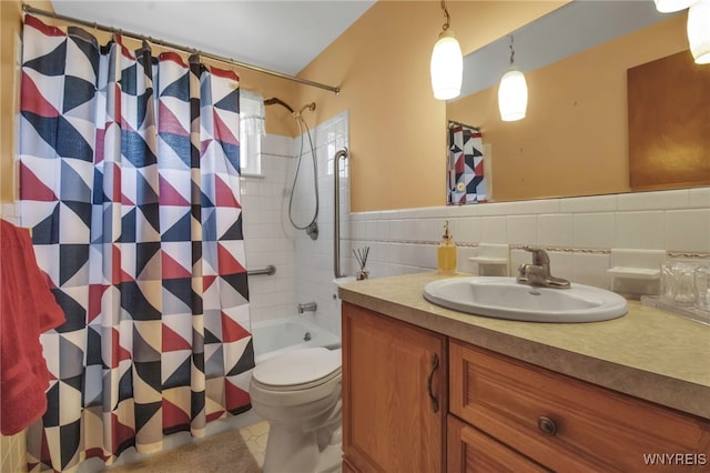 bathroom with vanity, tile walls, toilet, and shower / bathtub combination with curtain