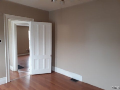 unfurnished bedroom featuring baseboards and wood finished floors