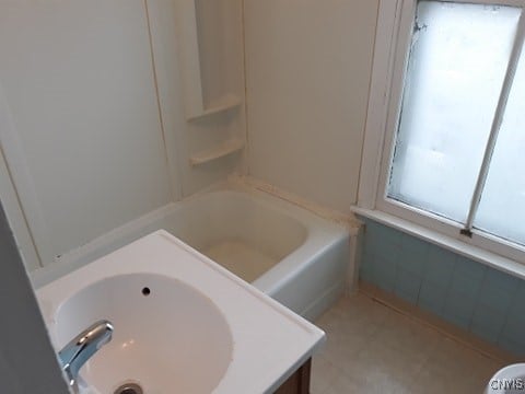 bathroom with a bath and a sink