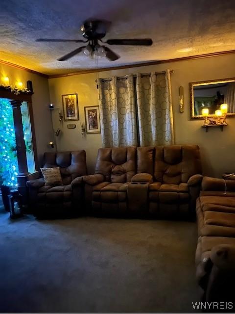 living area featuring ornamental molding, a textured ceiling, a ceiling fan, and carpet floors