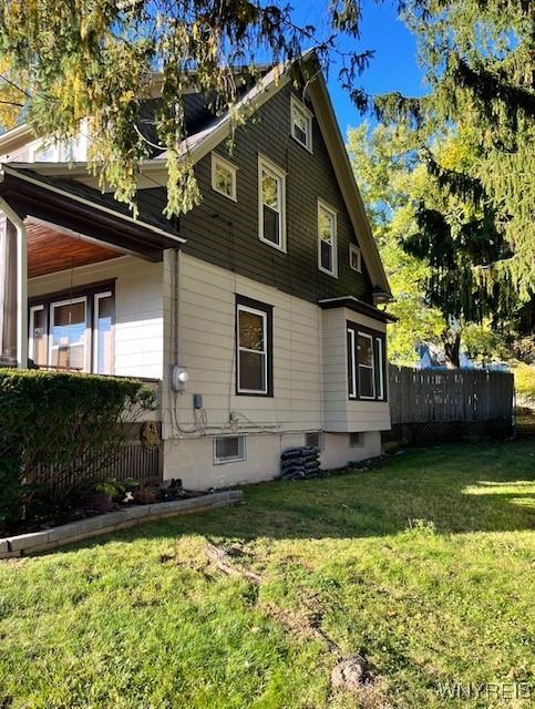 view of home's exterior featuring a yard and fence