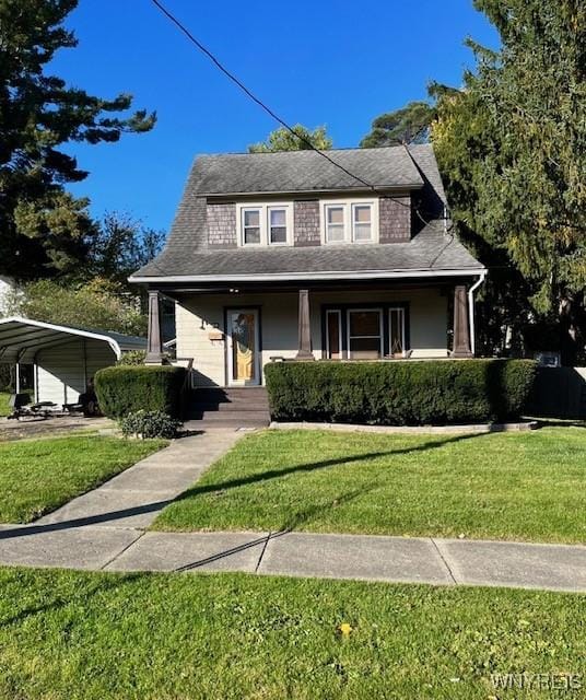 view of front of house featuring a front yard, a carport, and roof with shingles