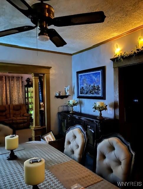 dining area with carpet floors, a textured ceiling, ornamental molding, and a ceiling fan