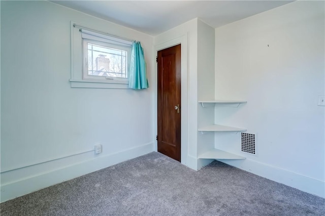 unfurnished bedroom featuring visible vents, baseboards, and carpet flooring