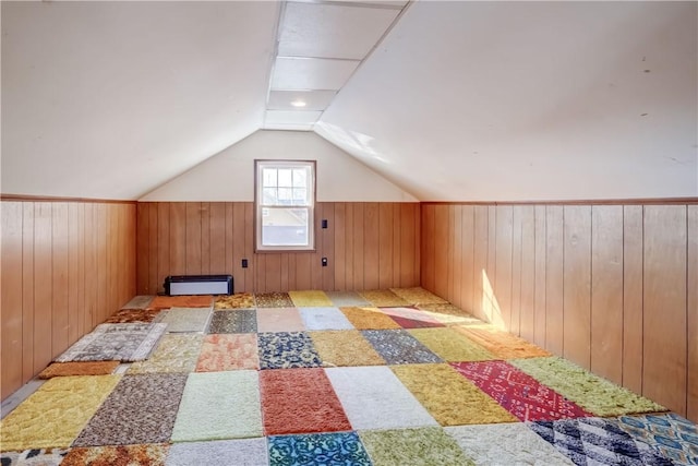 bonus room with vaulted ceiling, wood walls, and a baseboard radiator