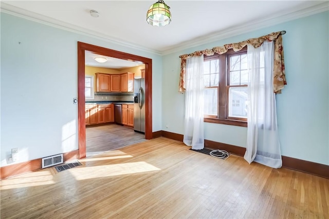 unfurnished dining area with plenty of natural light, visible vents, and light wood-type flooring