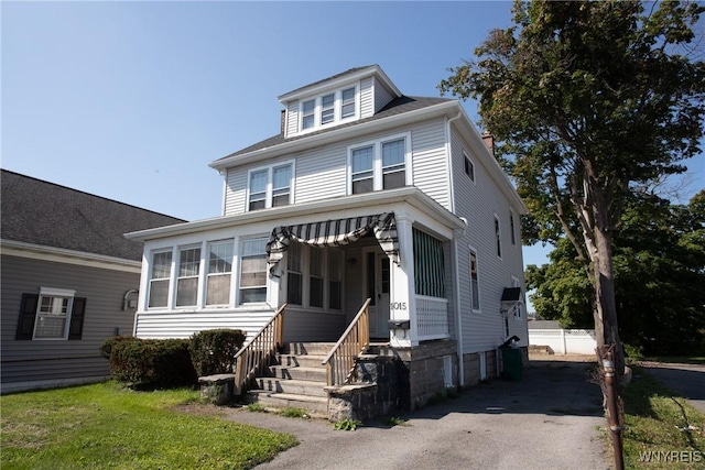 american foursquare style home with driveway