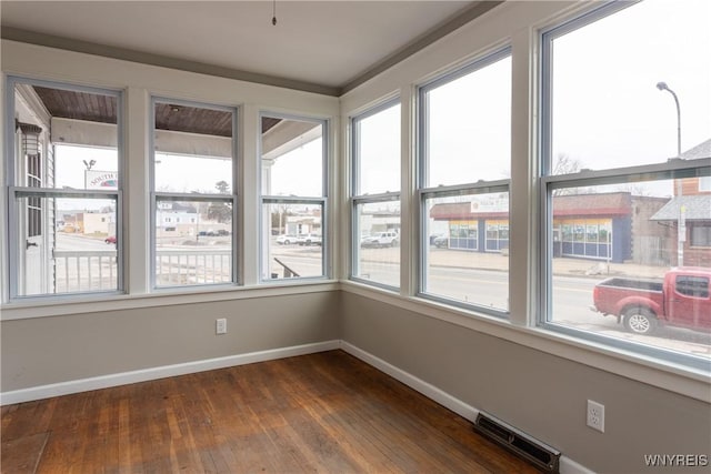 unfurnished sunroom with visible vents