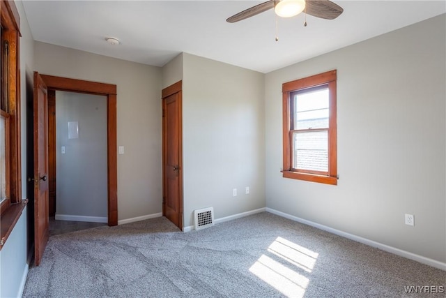 unfurnished bedroom with visible vents, baseboards, carpet floors, a closet, and a ceiling fan