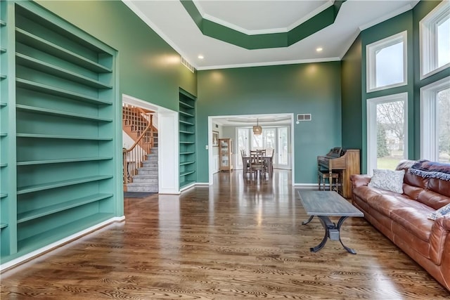 living room featuring visible vents, plenty of natural light, and wood finished floors