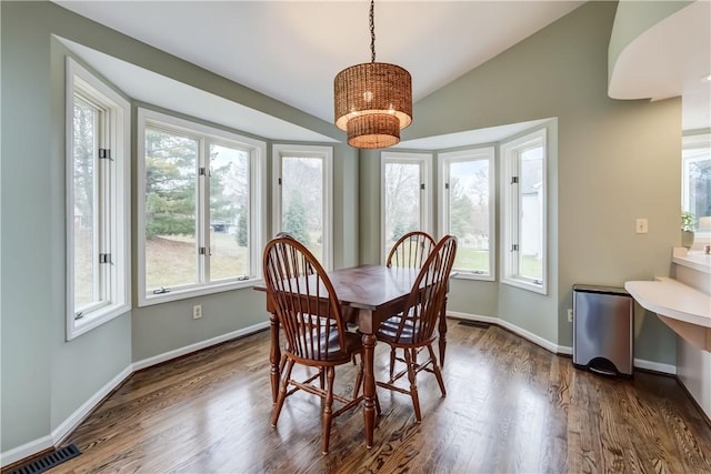 dining room with lofted ceiling, baseboards, visible vents, and dark wood-type flooring