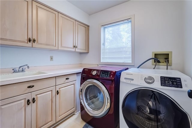 laundry area with a sink, cabinet space, and washing machine and dryer