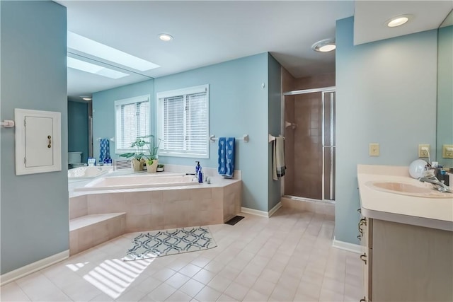 full bathroom with tile patterned floors, a stall shower, a skylight, a bath, and vanity