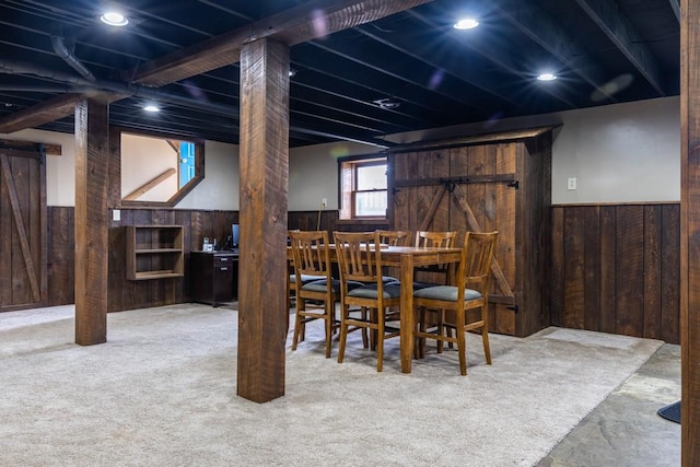 dining room featuring wooden walls, recessed lighting, wainscoting, a barn door, and carpet flooring