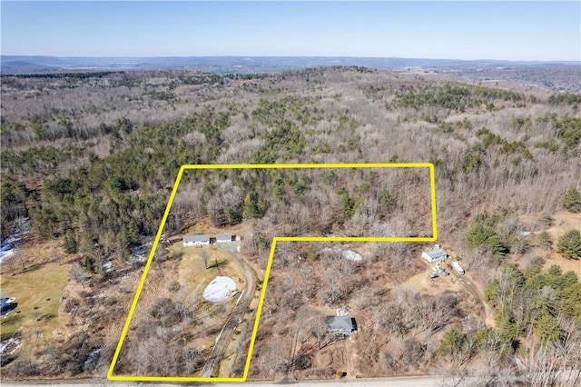 birds eye view of property with a forest view