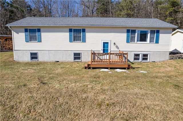 back of house with a wooden deck and a lawn