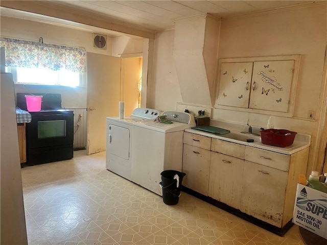 laundry room with laundry area, washer and dryer, crown molding, and light floors