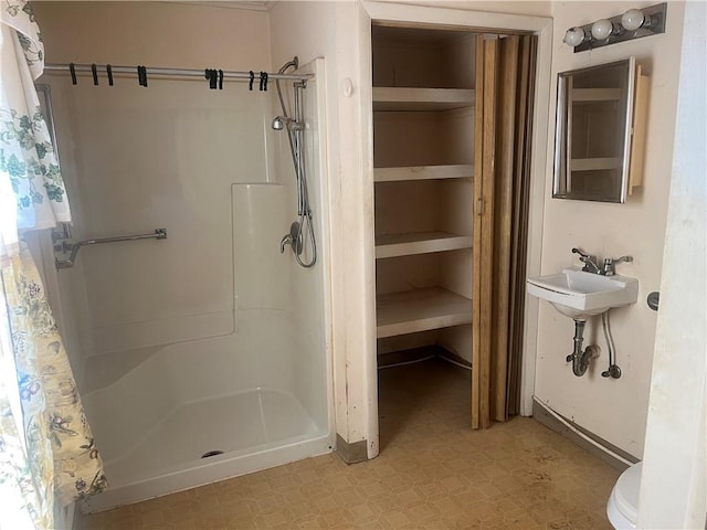 full bathroom with a shower stall and tile patterned floors