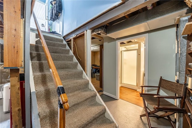 below grade area featuring stairway and baseboards