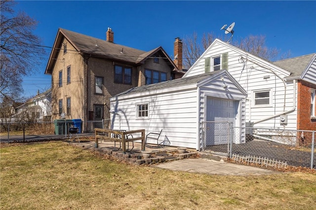 rear view of property with a yard, a patio area, an attached garage, and fence