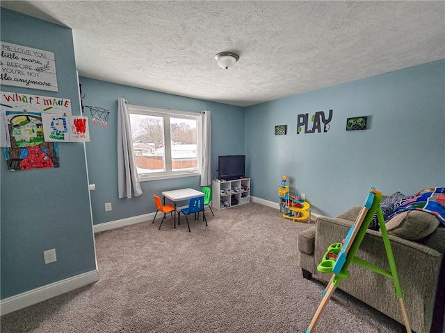 game room with carpet flooring, a textured ceiling, and baseboards