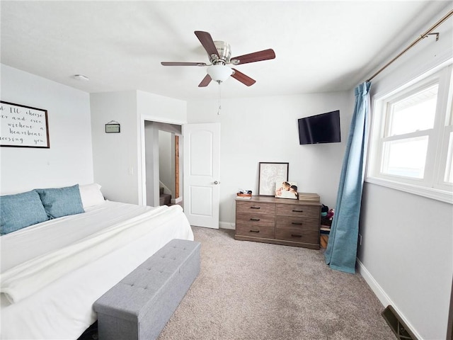 bedroom featuring visible vents, carpet flooring, baseboards, and a ceiling fan