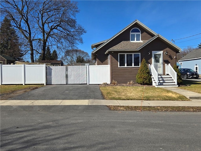 bungalow-style house featuring fence and a gate