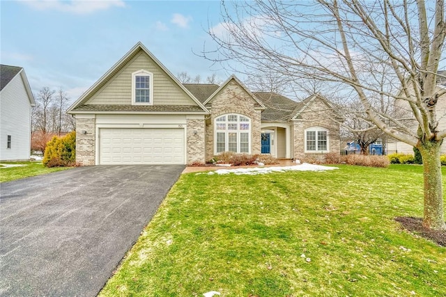 view of front of house featuring brick siding, a front lawn, and driveway