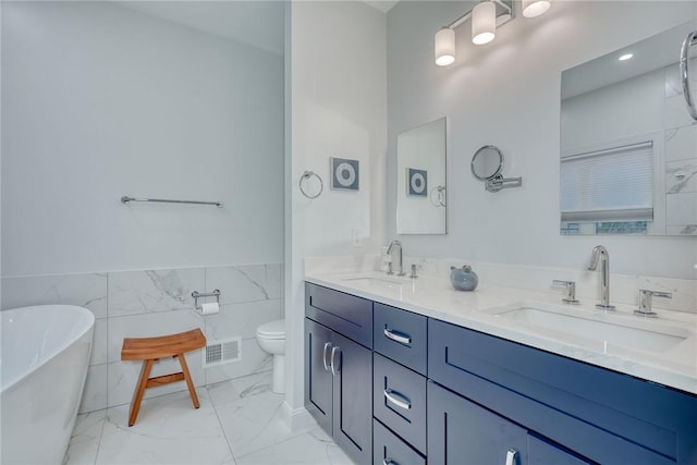 bathroom with double vanity, visible vents, marble finish floor, and a sink