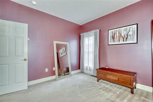 interior space with carpet flooring and baseboards