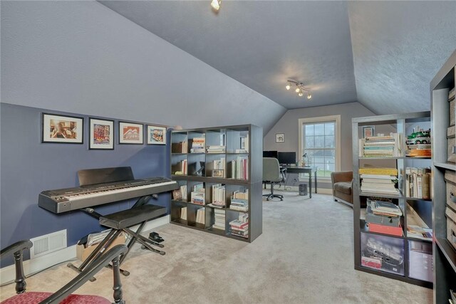 carpeted home office featuring lofted ceiling, baseboards, and a textured ceiling