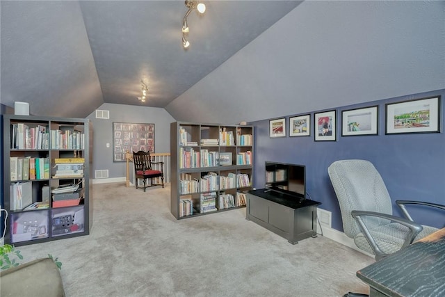 carpeted home office with visible vents, baseboards, and vaulted ceiling