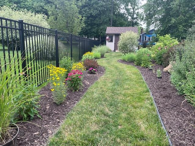 view of yard featuring an outbuilding and a fenced backyard