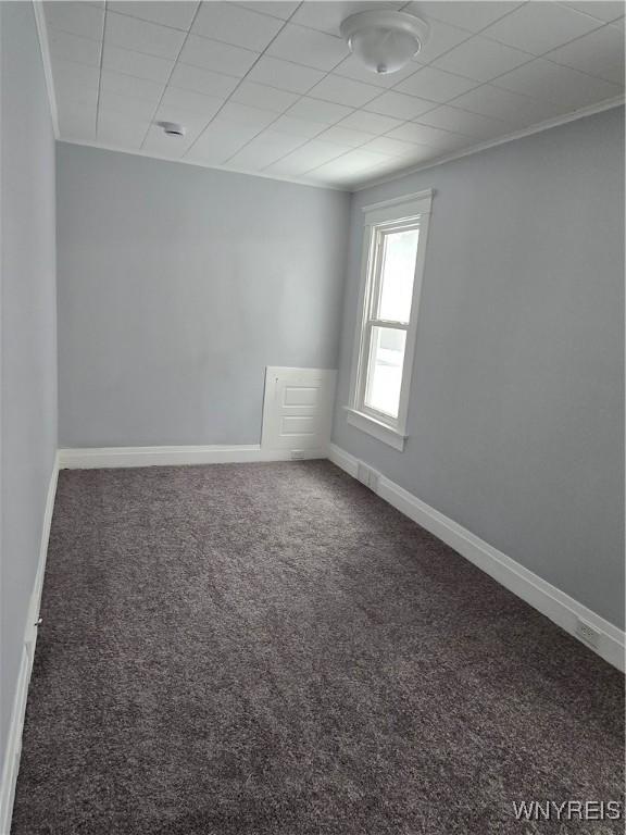 carpeted empty room with baseboards and ornamental molding