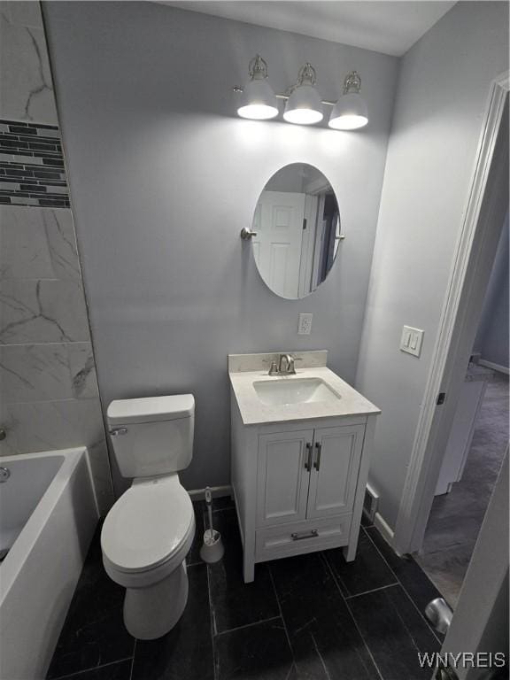 bathroom featuring toilet, vanity, and baseboards