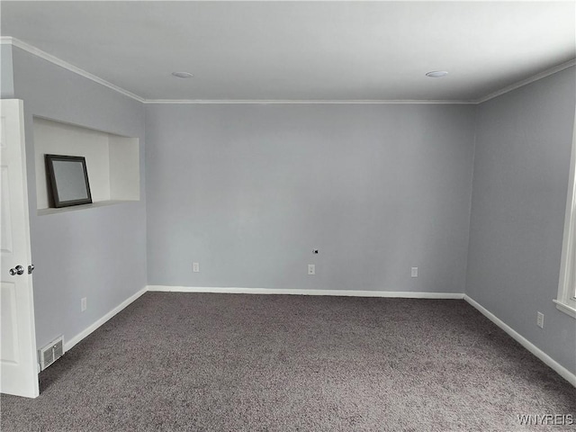 carpeted spare room with visible vents, crown molding, and baseboards