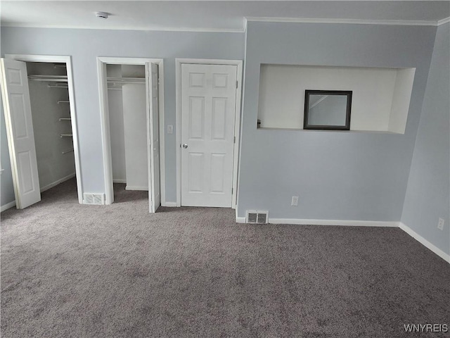 unfurnished bedroom with visible vents, carpet floors, baseboards, and crown molding