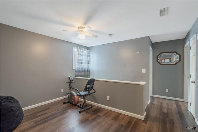 exercise room with visible vents, baseboards, wood finished floors, and a ceiling fan