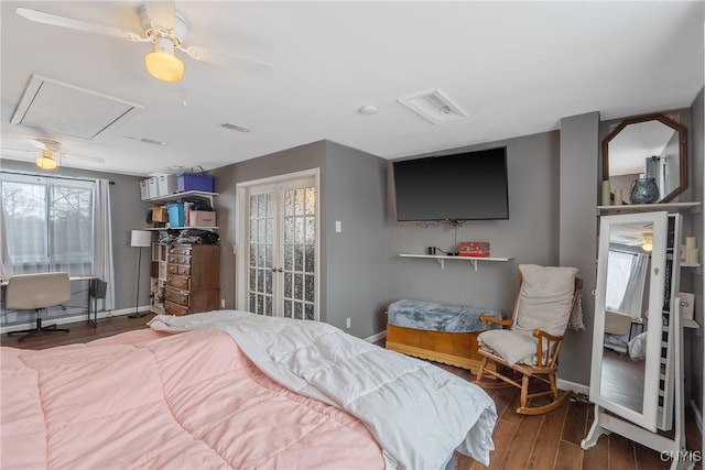 bedroom with a ceiling fan, baseboards, and wood finished floors