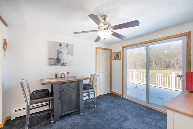 office space featuring dark carpet, a baseboard heating unit, baseboards, and ceiling fan