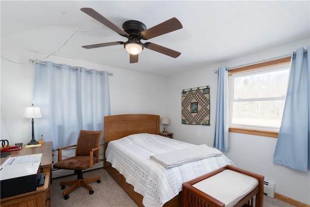 carpeted bedroom with ceiling fan and a baseboard radiator