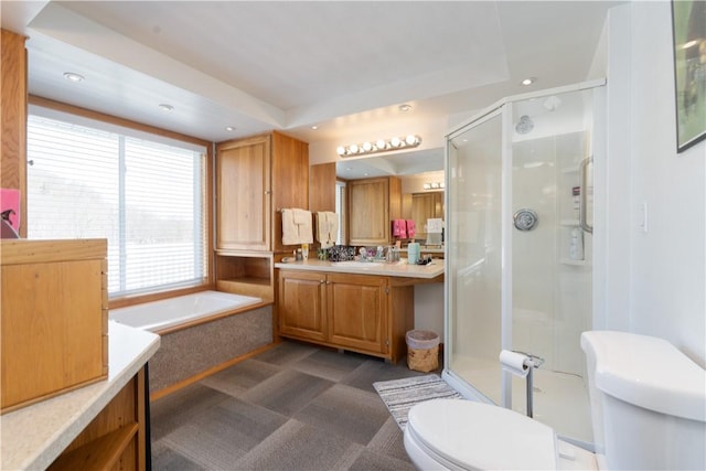 bathroom featuring vanity, a bath, recessed lighting, a shower stall, and toilet