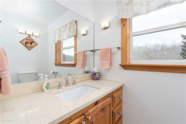 bathroom featuring toilet and vanity