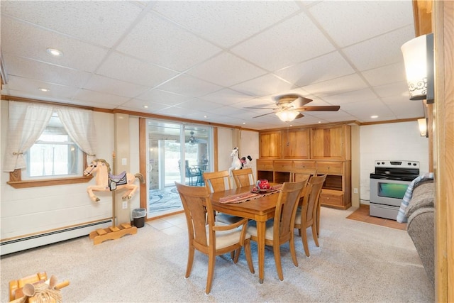 dining space with a baseboard heating unit, plenty of natural light, and ornamental molding