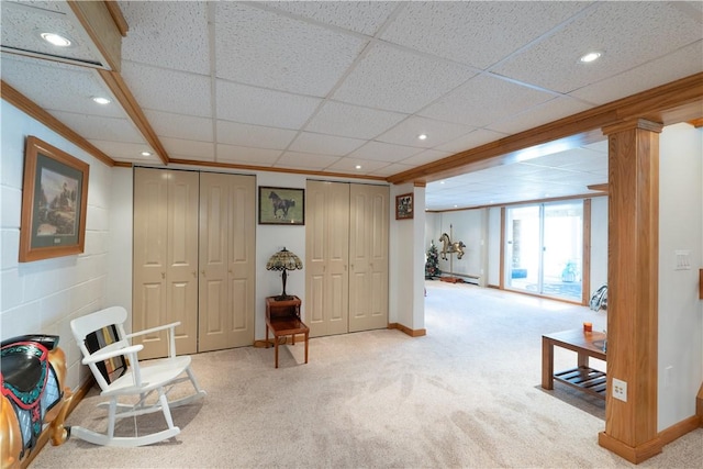 living area with recessed lighting, baseboards, ornamental molding, and carpet flooring